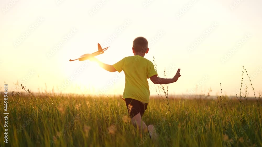 child runs with silhouette toy airplane in park field. childhood kid dream happy family concept. boy running with toy airplane in park at sunset. boy kid sunlight play dream of becoming a pilot child runs with silhouette toy airplane in park field. childhood kid dream happy family concept. boy running with toy airplane in park at sunset. boy kid sunlight play dream of becoming a pilot