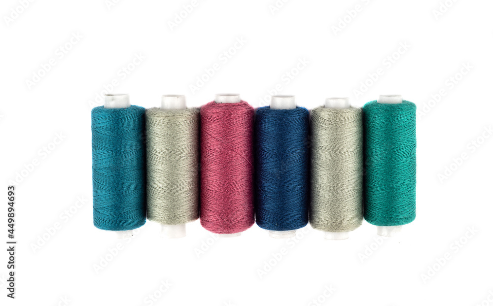 Top view of spools of colored thread on a white background. Top view of spools of colored thread on a white background.