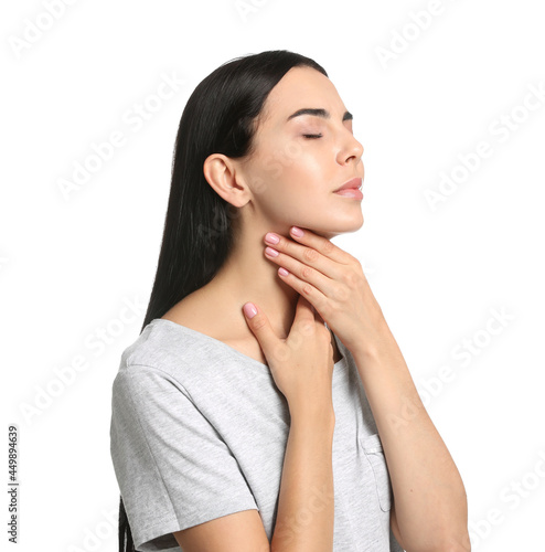Tableau sur toile Young woman doing thyroid self examination on white background