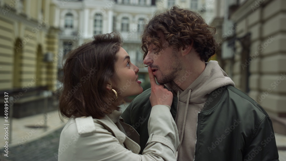 Happy couple spending time together in city. Woman flirting with man outdoor. Happy couple spending time together in city. Woman flirting with man outdoor.