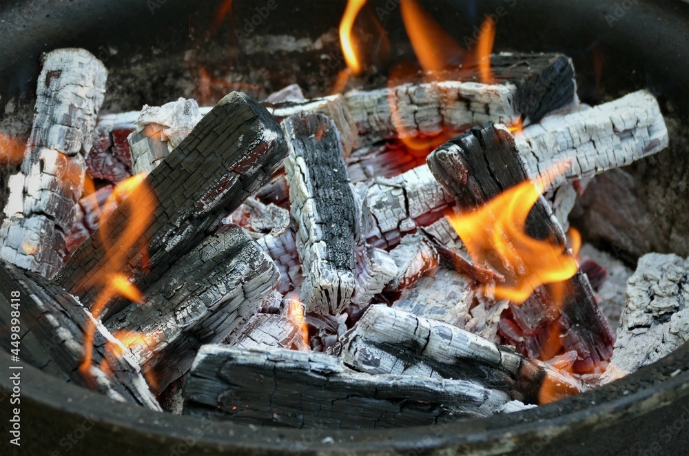 Wood in flame and ashes fire background Wood in flame and ashes fire background