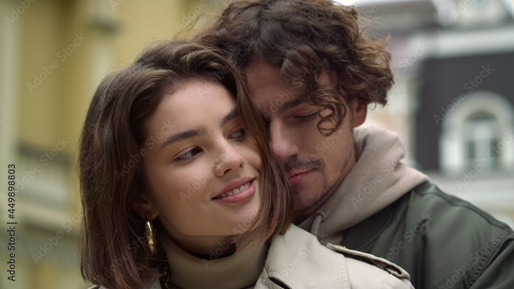 Affectionate couple hugging in city center. Guy and girl dating on urban street. Affectionate couple hugging in city center. Guy and girl dating on urban street.
