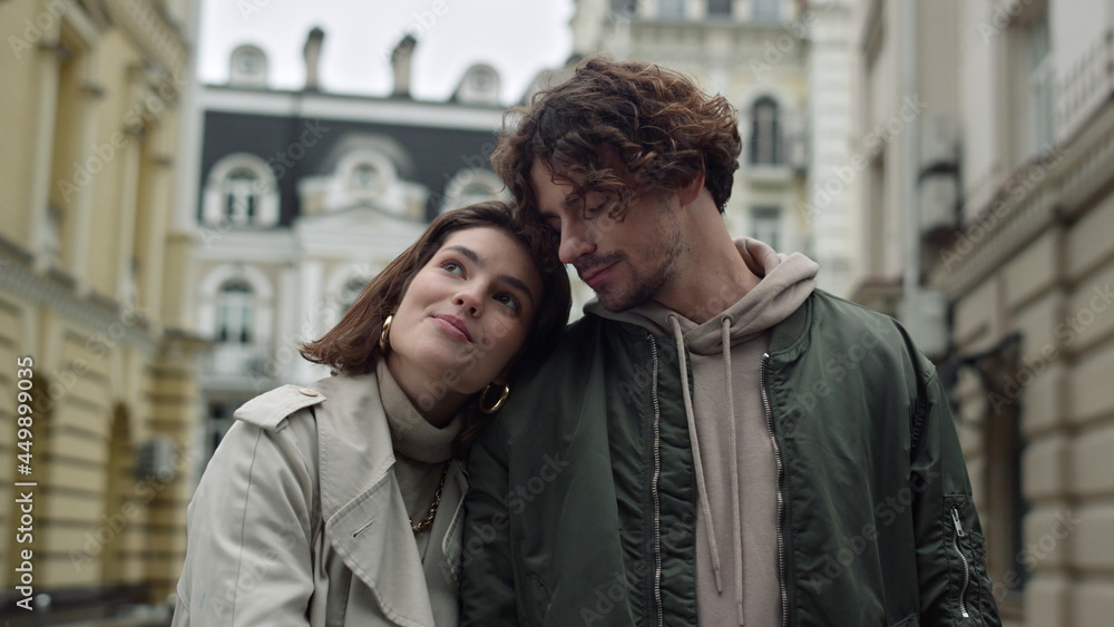 Happy couple cuddling together on street. Romantic man and woman having date. Happy couple cuddling together on street. Romantic man and woman having date.