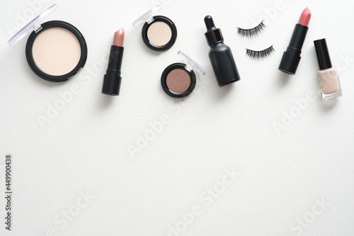 Frame of makeup cosmetics on white background. Flat lay, top view. Face skin care concept.