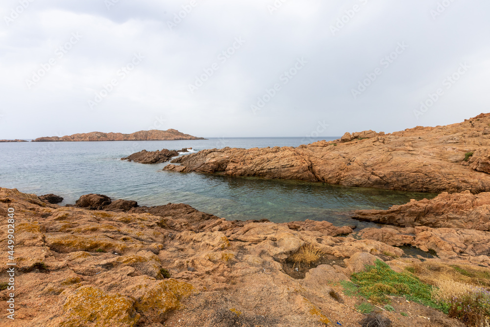beautiful beach and characteristic reddish rocks of Isola Rossa, Costa Paradiso. Trinità d'Agultu e Vignola, Sardinia, Italy, Europe