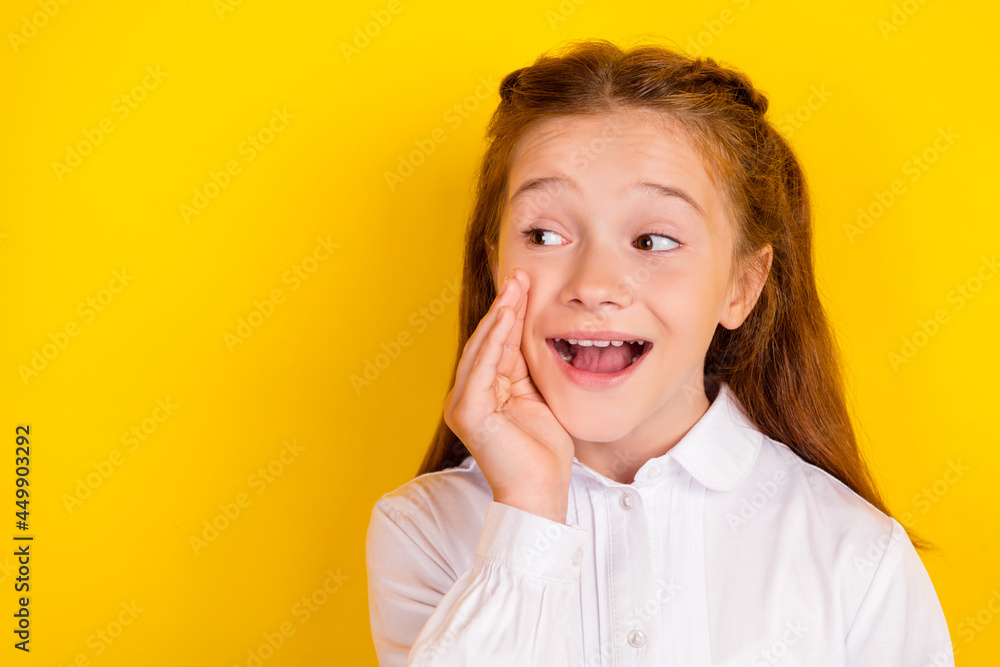 Photo of young beautiful lovely smiling girl look copyspace whisper secret rumor isolated on yellow color background Photo of young beautiful lovely smiling girl look copyspace whisper secret rumor isolated on yellow color background