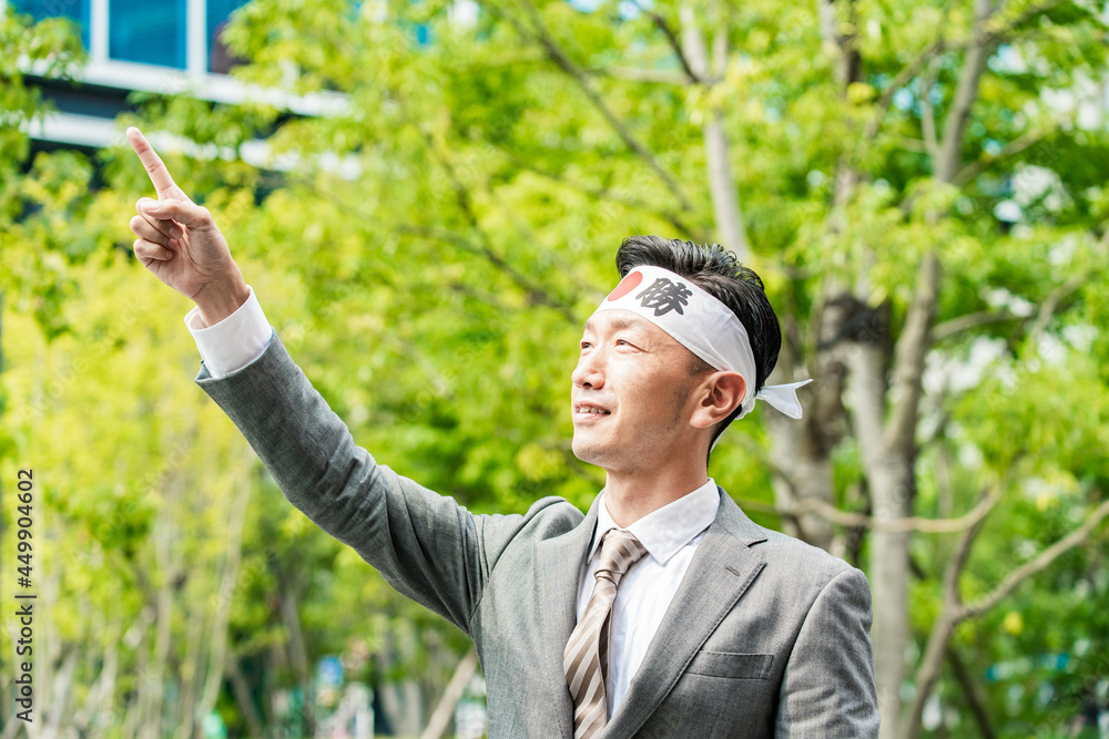 「必勝」の鉢巻を巻いて手を上げる男性 Stock Photo | Adobe Stock