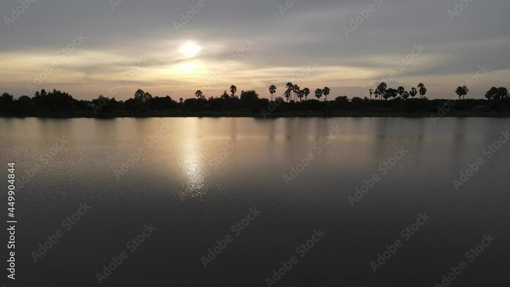 The drone flies over the water at high speed at dusk. The drone flies over the water at high speed at dusk.