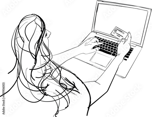 Online shopping and payment concept with female at desk typing on computer keyboard and holding a credit card