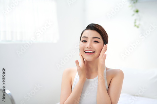 Beauty portrait of a young woman touches the face with even clean skin Free Download Beauty portrait of a young woman touches the face with even clean skin - GFXLoad