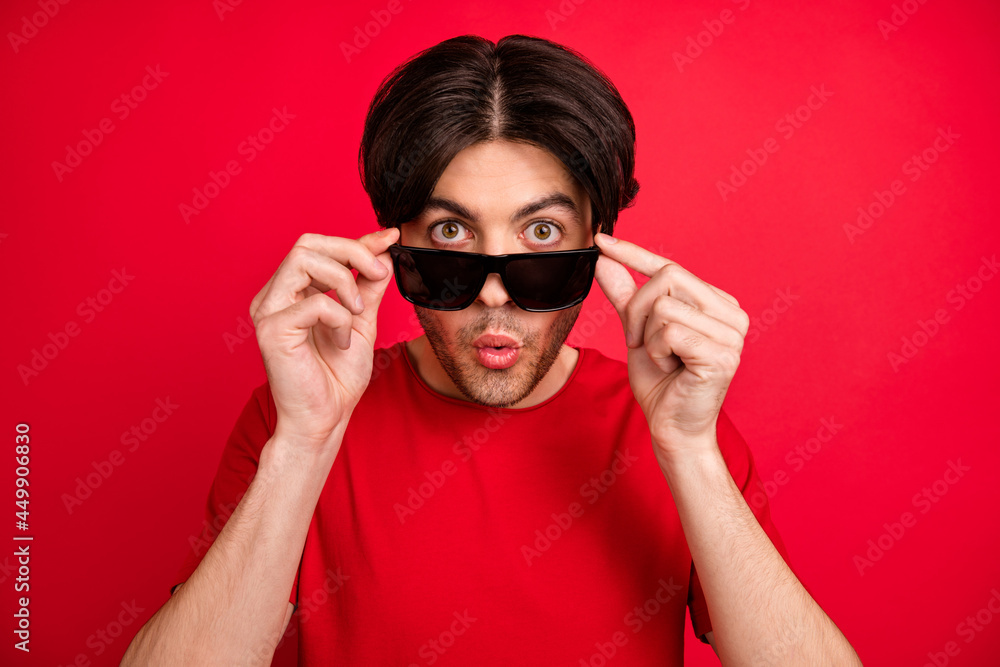 Photo of shocked crazy guy take off sunglass excited omg reaction wear red t-shirt isolated red color background Photo of shocked crazy guy take off sunglass excited omg reaction wear red t-shirt isolated red color background