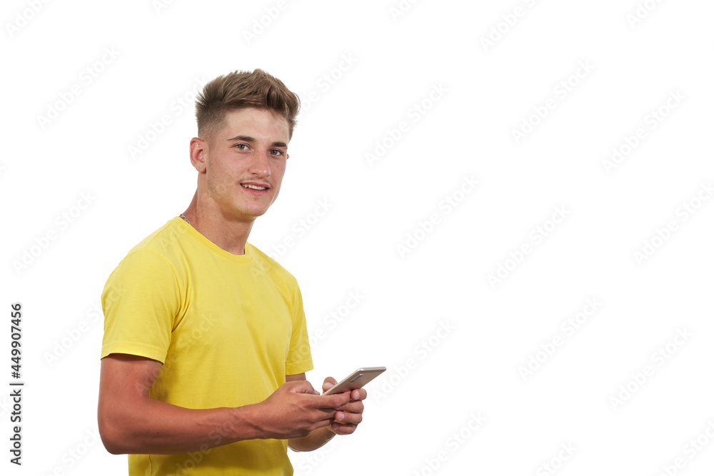 portrait of handsome man dressed casual in yellow t-shirt. Using the smart phone portrait of handsome man dressed casual in yellow t-shirt. Using the smart phone