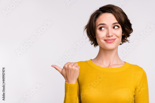 Photo of young girl happy positive smile point thumb empty space ad advice choose isolated over grey color background