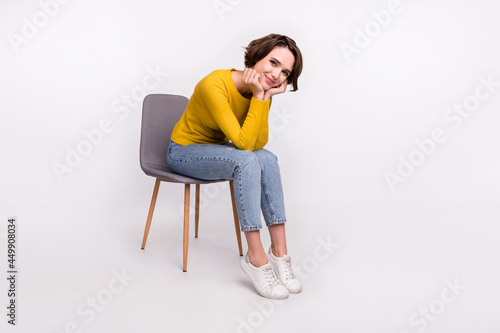 Obraz na plátně Photo of adorable positive cheerful nice girl hands cheeks sit chair wear yellow