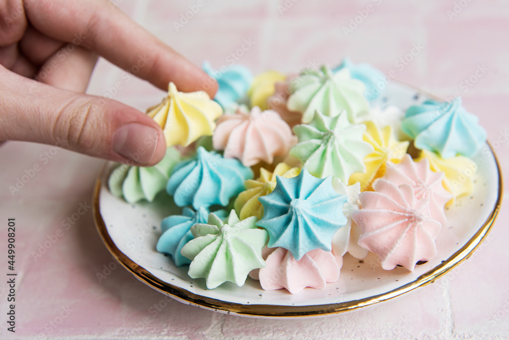 Small colorful meringues in the ceramic plate Small colorful meringues in the ceramic plate