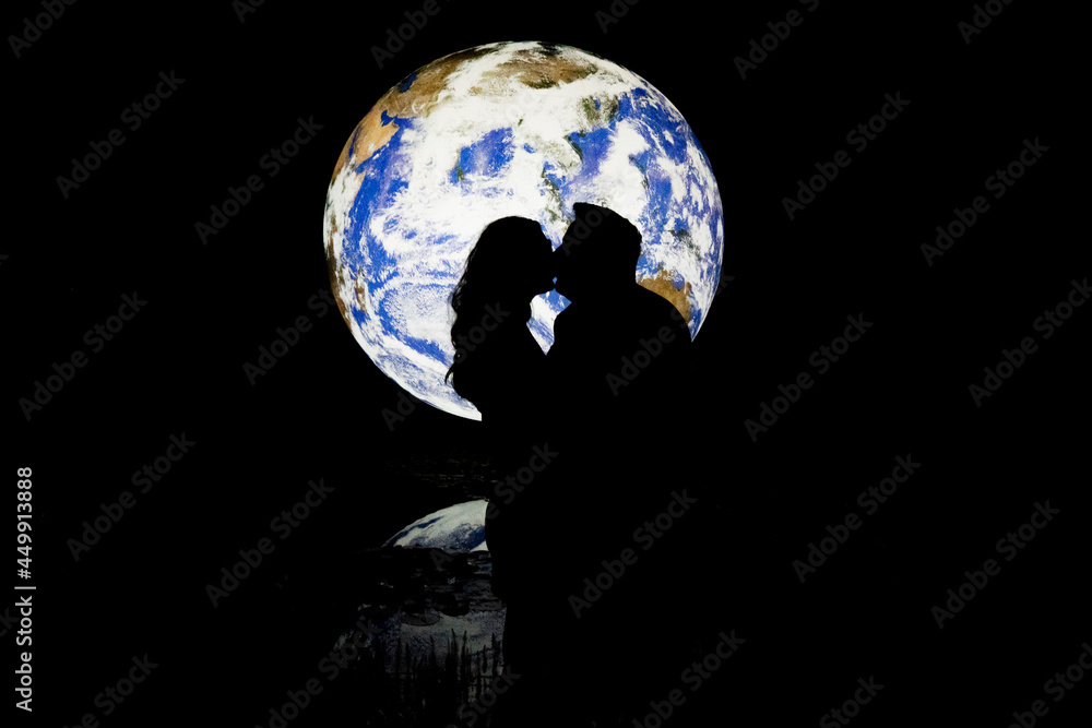 Couple kissing with the earth in the background 
