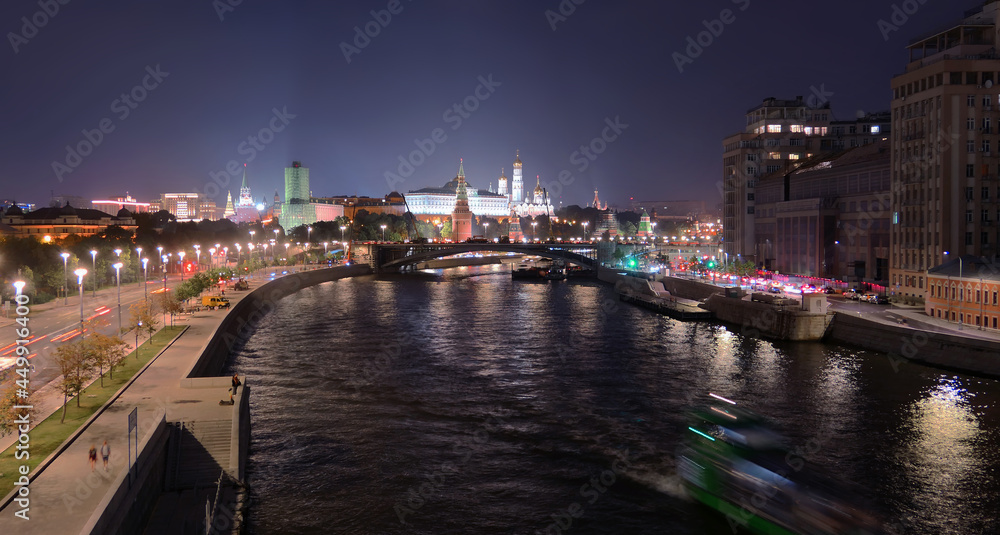 Illuminated Moscow river tonight with nice reflections and historical buildings with Kremlin, Red wall and bridge under construction