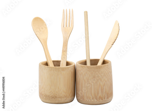 Bamboo wood cutlery, disposable fork, spoon,knife and straw in bamboo cup made of natural material isolated on white background. Ecological concept.