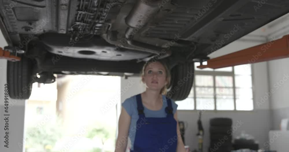 Female mechanic working under a car Female mechanic working under a car