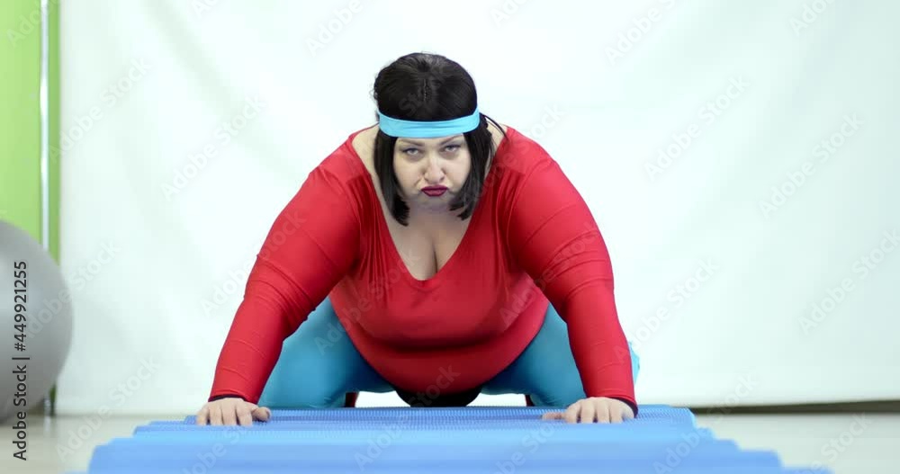 Fat woman lies down on the fitness mat. Overweight. Fat woman lies down on the fitness mat. Overweight.