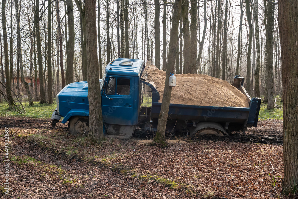 Dump truck car stuck in mud on the road. Blurry mud bad road in the