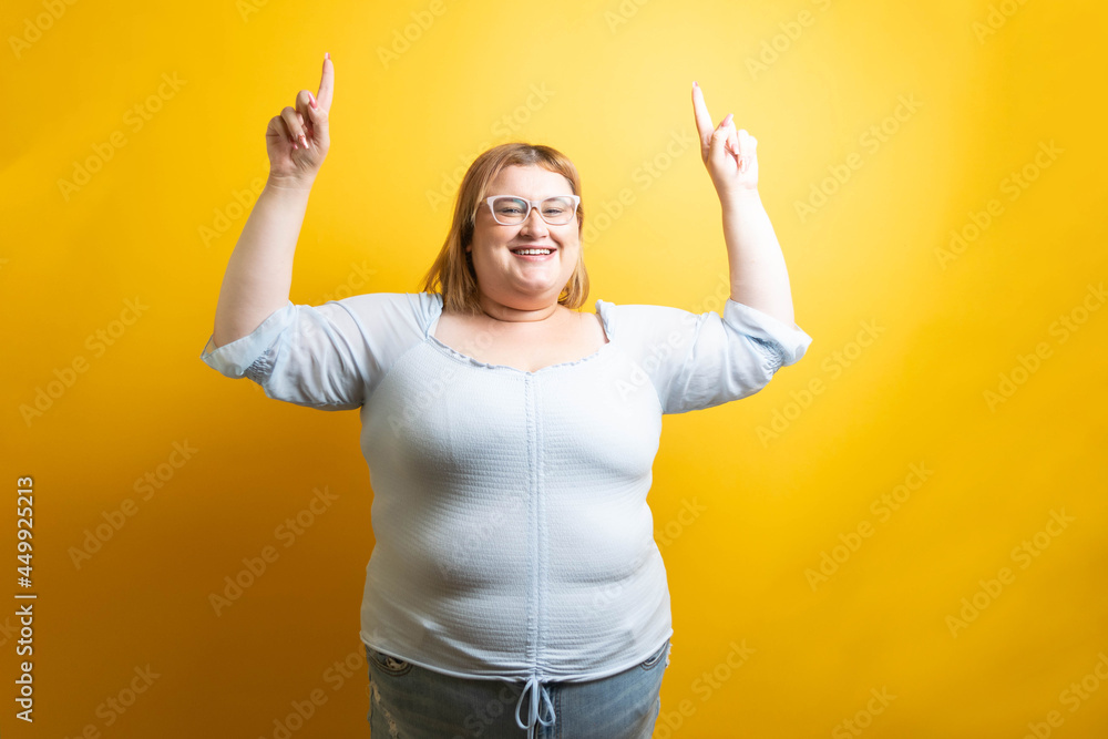 overweight young caucasian model pointing up overweight young caucasian model pointing up
