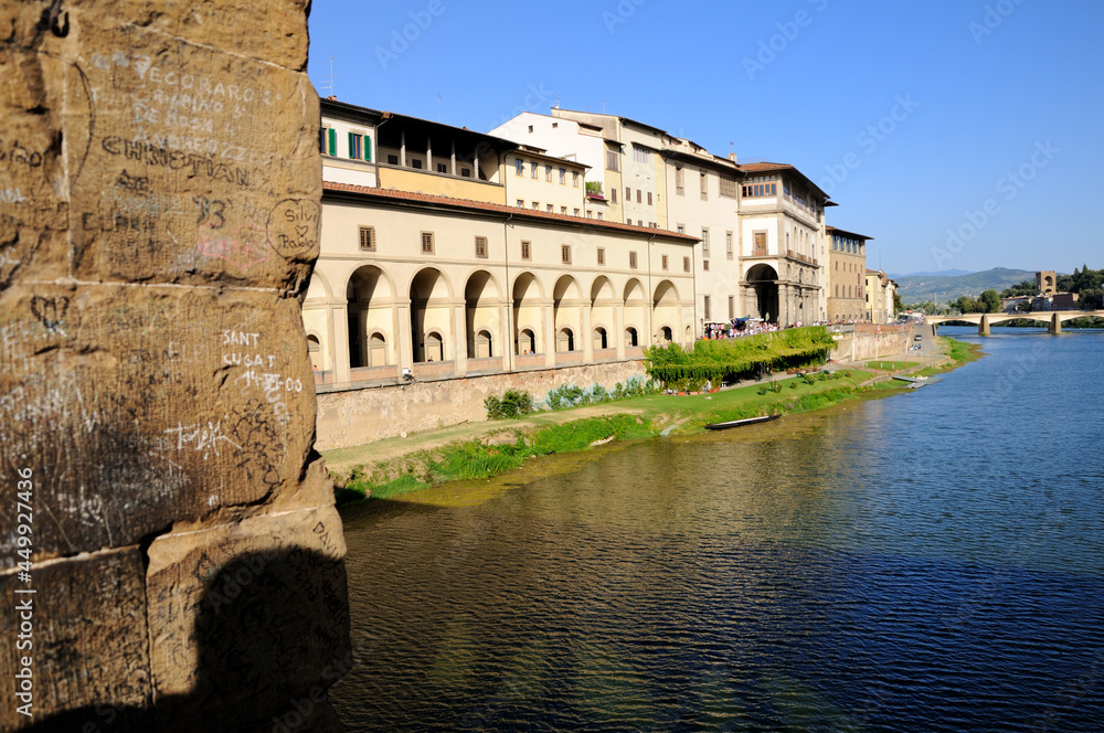 View of the buildings on the river Arno bank from the Old Bridge (Ponte Vecchio). Florence, Italy.