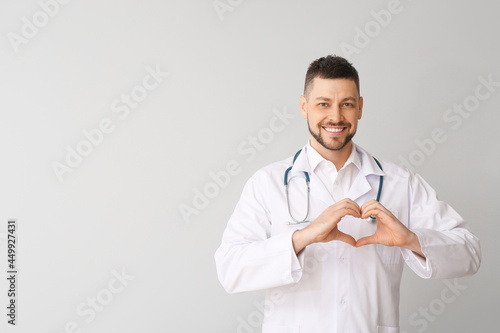 Cardiologist making heart w...