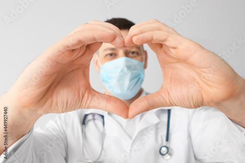 Cardiologist making heart w...