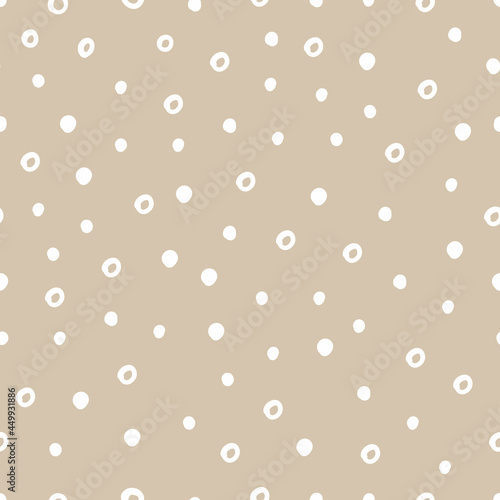 Vector abstract cute hand drawn seamless pattern with a irregular dots on a beige background. Pastel baby texture ideal for fabric, wallpaper, wrapping paper, card, layout. Delicate children's print.