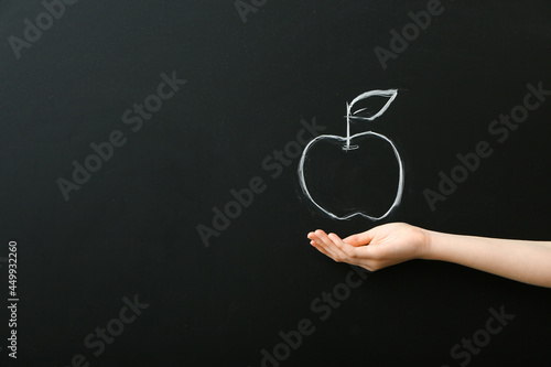 Female hand and drawn apple...