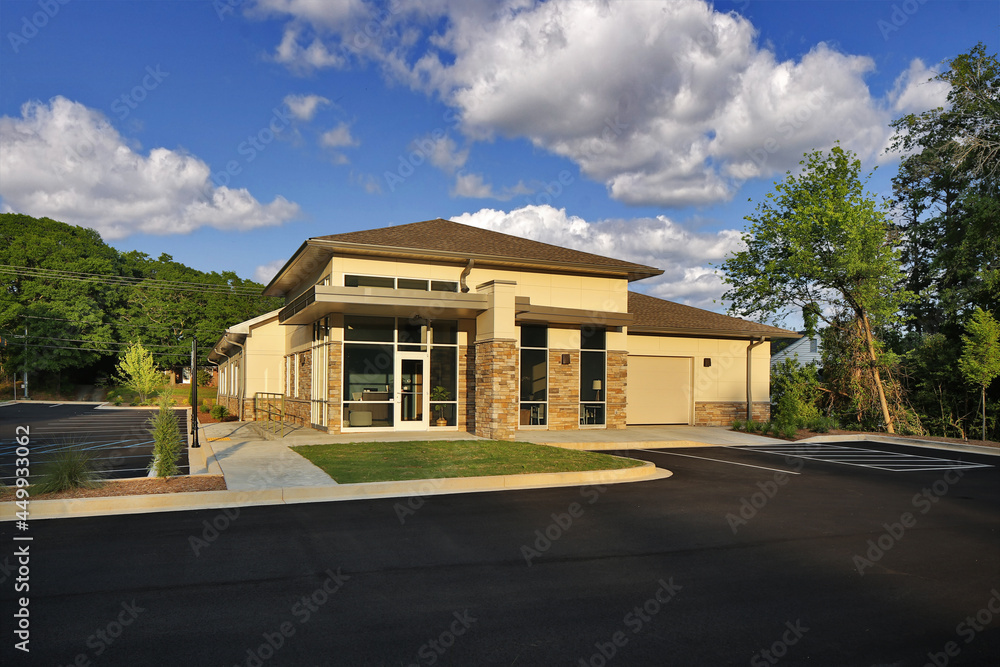 Modern tan and brown dentistry business building entrance with stonework Modern tan and brown dentistry business building entrance with stonework