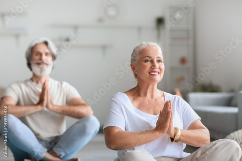 Mature couple practicing yo...