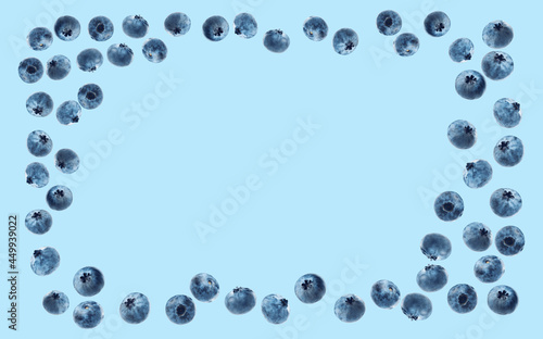 blue background with ripe blueberries