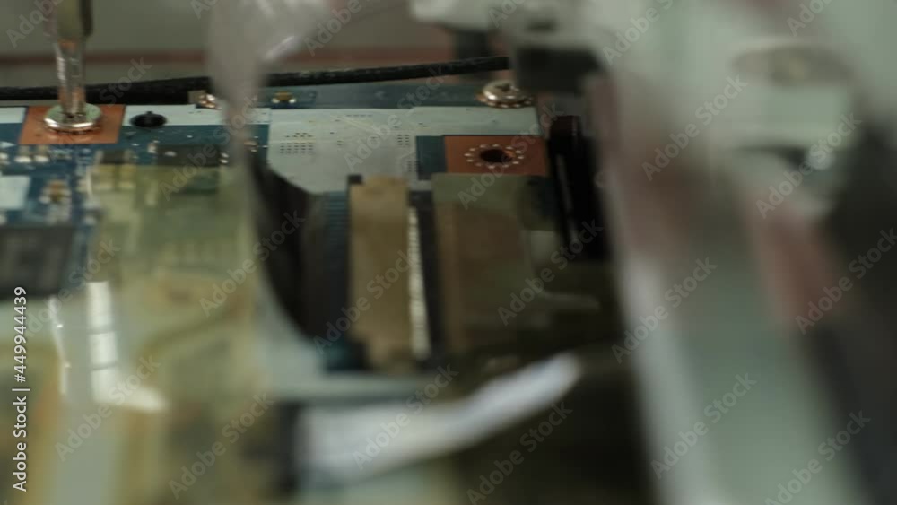 The process of unscrewing the screws on the parts of the laptop for repair. Laptop repair. Computer repair service The process of unscrewing the screws on the parts of the laptop for repair. Laptop repair. Computer repair service
