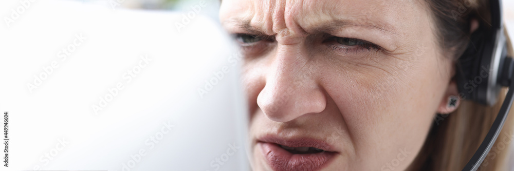 Portrait of woman with poor eyesight who looks into monitor Portrait of woman with poor eyesight who looks into monitor