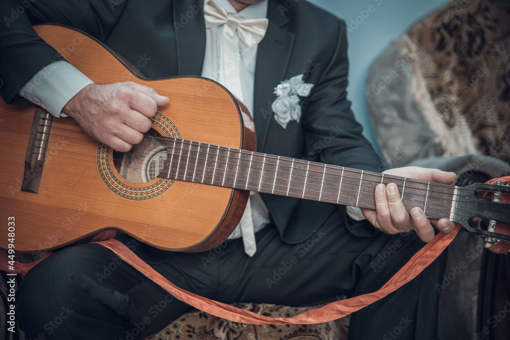 the groom plays the guitar. male musician