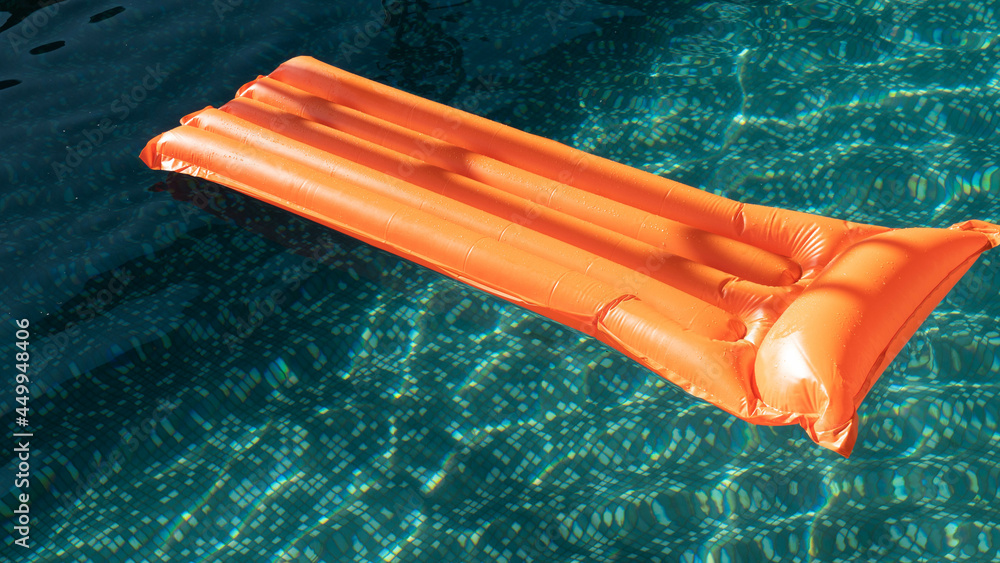 Pink inflatable mattress floating on water surface. Lifebuoy. vacation concept. inflatable ring