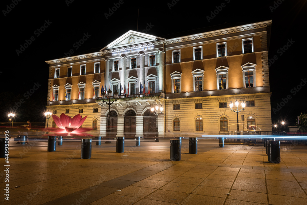 Fototapeta premium Night view of the City Hall building (Hotel de Ville d'Annecy) illuminated from the Hotel de Ville Square, Annecy, France