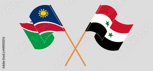 Crossed and waving flags of Namibia and Syria