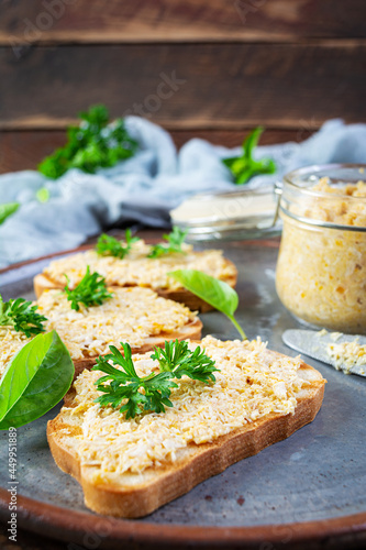 Delicious toasts with homemade chicken rillettes. Sandwich snack with chicken pate on wooden background