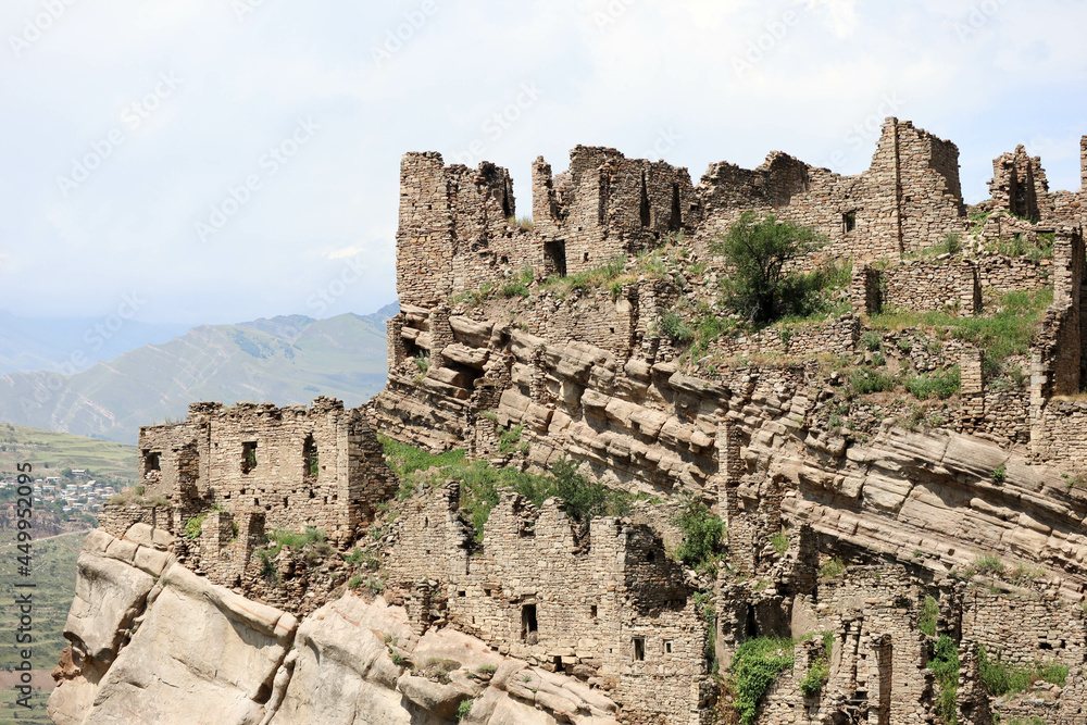 ruined stone houses on the slopes of caucasus mountains in abandoned ancient village old Kahib in Dagestan