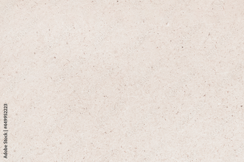 A sheet of hardboard covered with small dots, scratches and inclusions. Cardboard mottled heterogeneous texture.