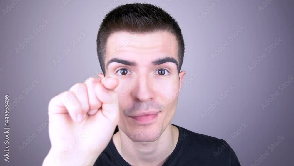The young man points his finger at you The young man points his finger at you