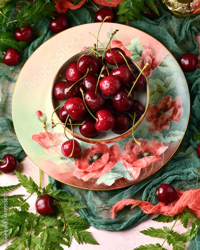 Cherries in a plate on the table, top view, selective focus, water drops on berries