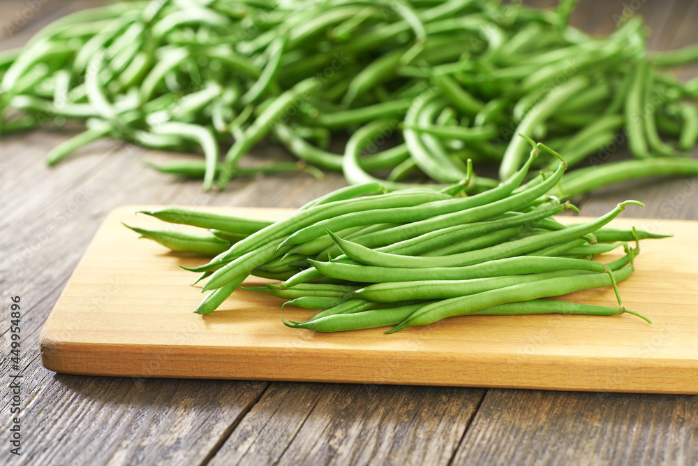 green bean pods on a cutting board, rustic style. green bean pods on a cutting board, rustic style.