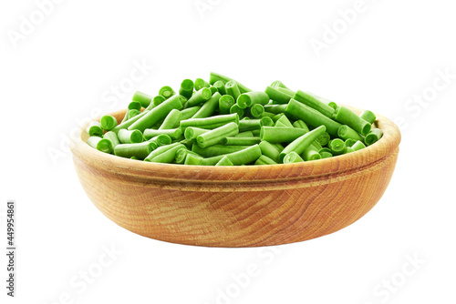 chopped green beans in a wooden bowl isolated on white background.