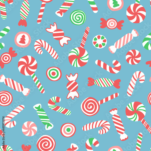 Vector seamless pattern with hand drawn candy canes, lollipops and candies. Cute design for Christmas wrappings, textile and backgrounds.