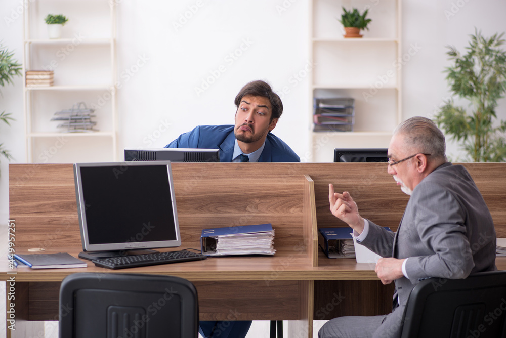 Two male employees working in the office Two male employees working in the office