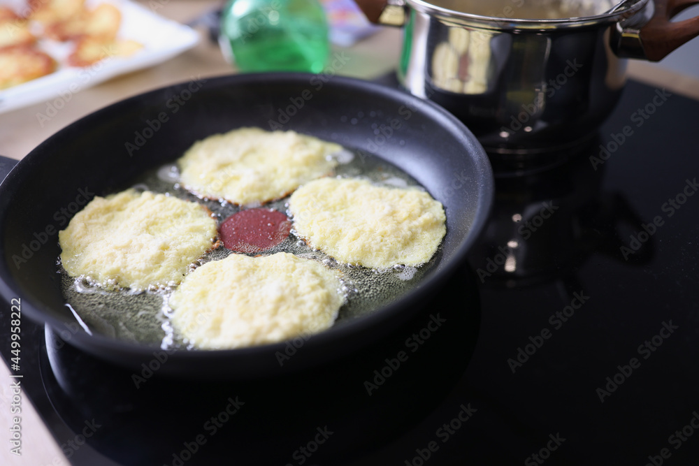 Flour pancakes are fried in pan closeup Flour pancakes are fried in pan closeup